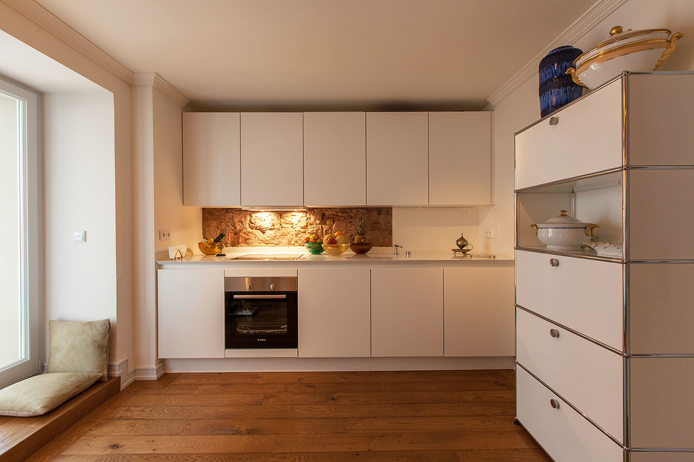 Design ideas for a medium sized contemporary single-wall enclosed kitchen in Dusseldorf with flat-panel cabinets, white cabinets, brown splashback, stone tiled splashback, integrated appliances, dark hardwood flooring and no island.