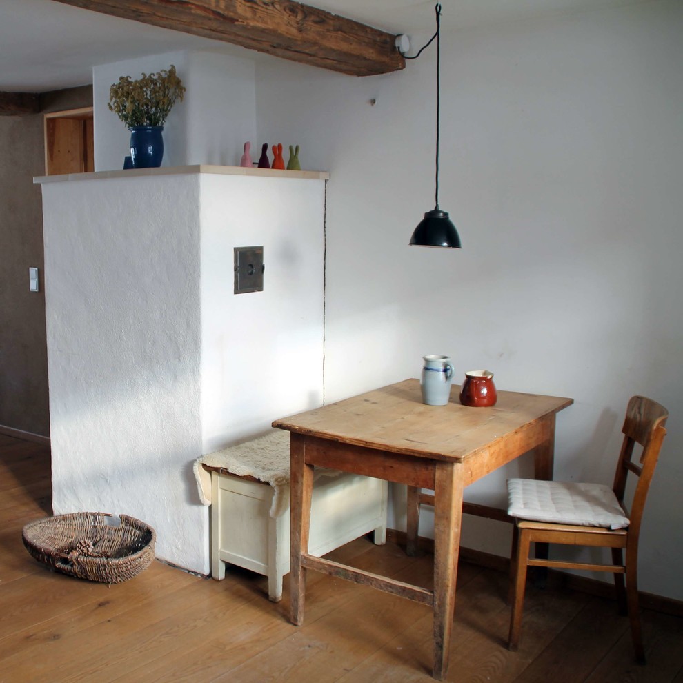 Mittelgroße Country Wohnküche ohne Insel in L-Form mit Arbeitsplatte aus Holz, Küchenrückwand in Weiß und dunklem Holzboden in Sonstige