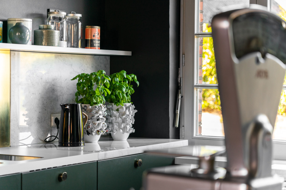 Inspiration for a small industrial galley open plan kitchen in Dortmund with a double-bowl sink, flat-panel cabinets, green cabinets, marble worktops, metallic splashback, marble splashback, integrated appliances, ceramic flooring, an island, black floors and white worktops.