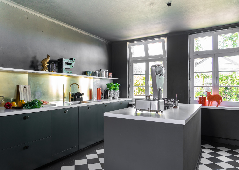 This is an example of an urban kitchen in Dortmund with a double-bowl sink, flat-panel cabinets, green cabinets, marble worktops, metallic splashback, ceramic flooring, an island, white worktops and multi-coloured floors.