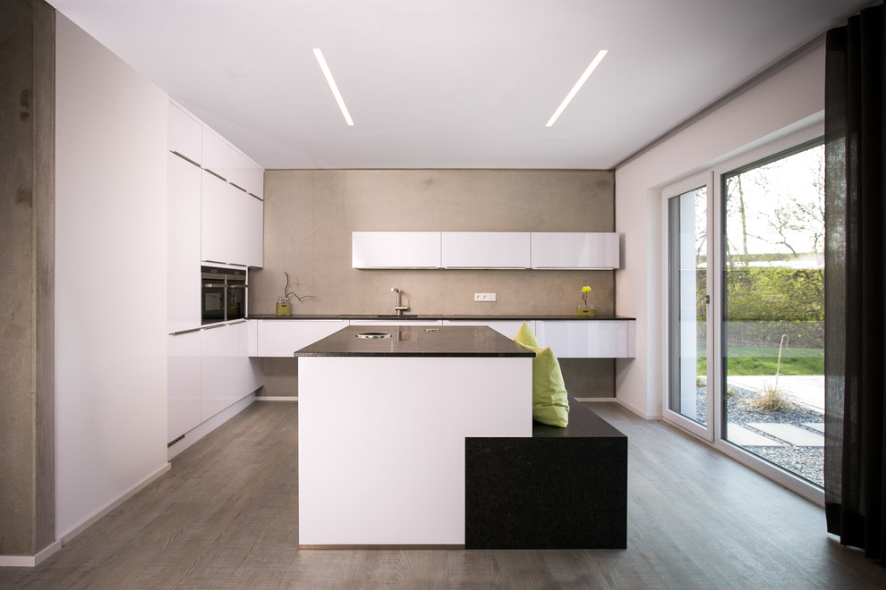 Design ideas for a large modern l-shaped open plan kitchen in Other with an island, flat-panel cabinets, white cabinets, grey splashback, stainless steel appliances and medium hardwood flooring.