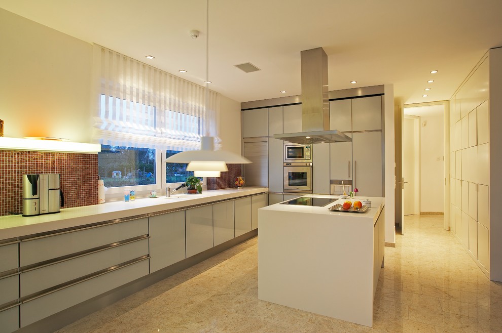 Design ideas for a large contemporary l-shaped enclosed kitchen in Hamburg with an integrated sink, glass-front cabinets, grey cabinets, composite countertops, multi-coloured splashback, mosaic tiled splashback, stainless steel appliances, marble flooring, an island and beige floors.