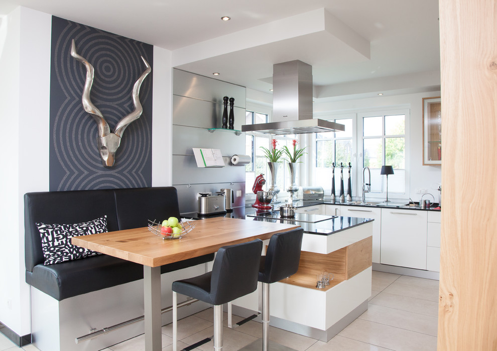 Design ideas for a medium sized contemporary u-shaped open plan kitchen in Bremen with flat-panel cabinets, white cabinets, an island, an integrated sink, granite worktops, white splashback, window splashback, stainless steel appliances and beige floors.