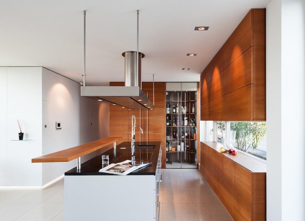 Open concept kitchen - mid-sized contemporary open concept kitchen idea in Munich with an undermount sink, flat-panel cabinets, medium tone wood cabinets, paneled appliances and an island