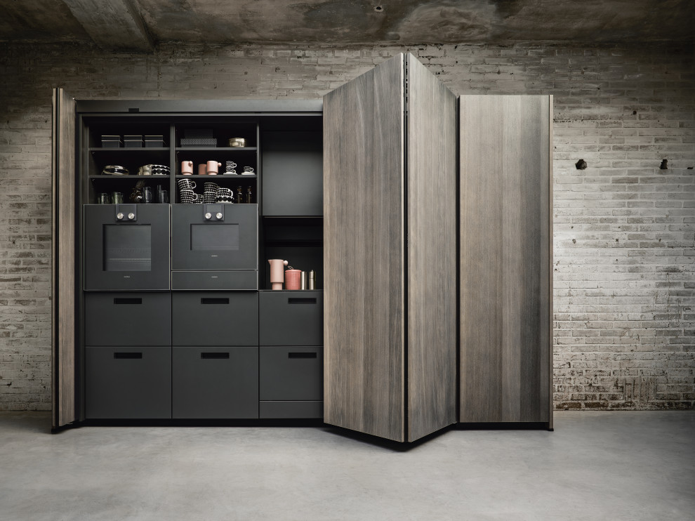 Inspiration for a scandinavian open concept kitchen remodel in Nuremberg with flat-panel cabinets, dark wood cabinets, black backsplash, black appliances and black countertops