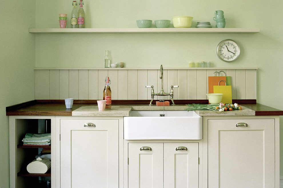 Country kitchen photo in Dusseldorf with a farmhouse sink, white cabinets, shaker cabinets and marble countertops