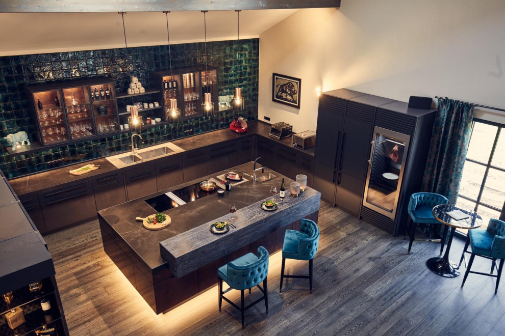 Inspiration for a large urban u-shaped open plan kitchen in Munich with a submerged sink, flat-panel cabinets, tile countertops, green splashback, metro tiled splashback, dark hardwood flooring, an island, black worktops and exposed beams.