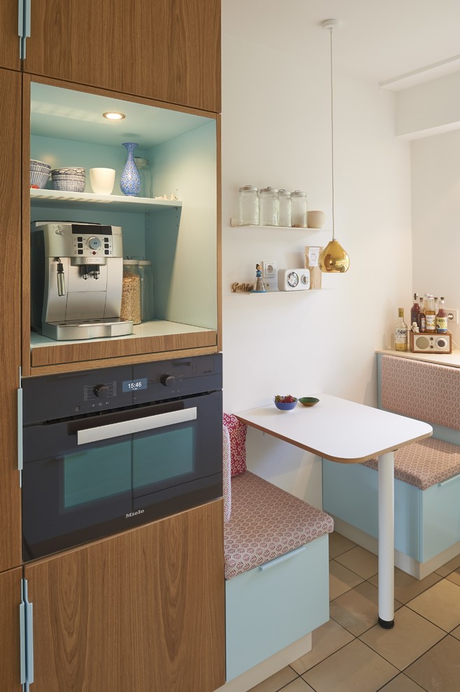 Kleine Nordische Wohnküche mit braunem Boden in Köln