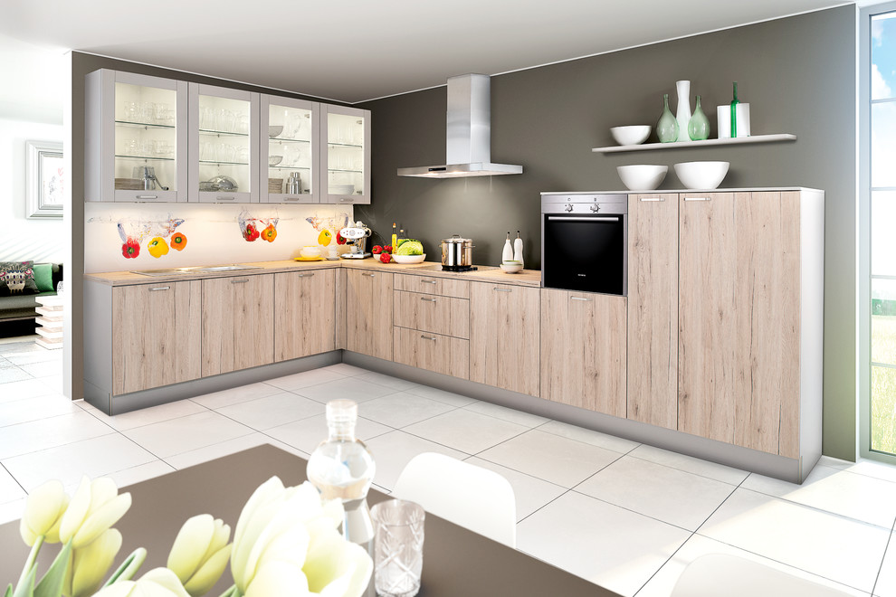 This is an example of a medium sized scandi l-shaped open plan kitchen in Hanover with flat-panel cabinets, medium wood cabinets, wood worktops, no island and brown worktops.
