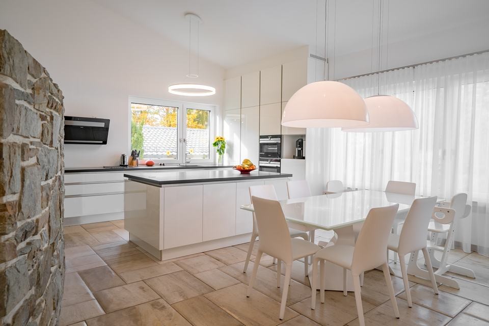 This is an example of a large contemporary l-shaped open plan kitchen in Frankfurt with an integrated sink, flat-panel cabinets, white cabinets, granite worktops, white splashback, window splashback, stainless steel appliances, marble flooring and an island.