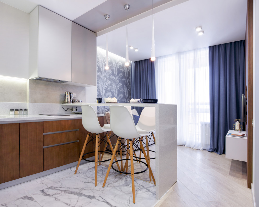 Photo of a small contemporary l-shaped open plan kitchen in Novosibirsk with laminate floors, beige floors, a submerged sink, flat-panel cabinets, medium wood cabinets, composite countertops, white splashback, stainless steel appliances, a breakfast bar and white worktops.