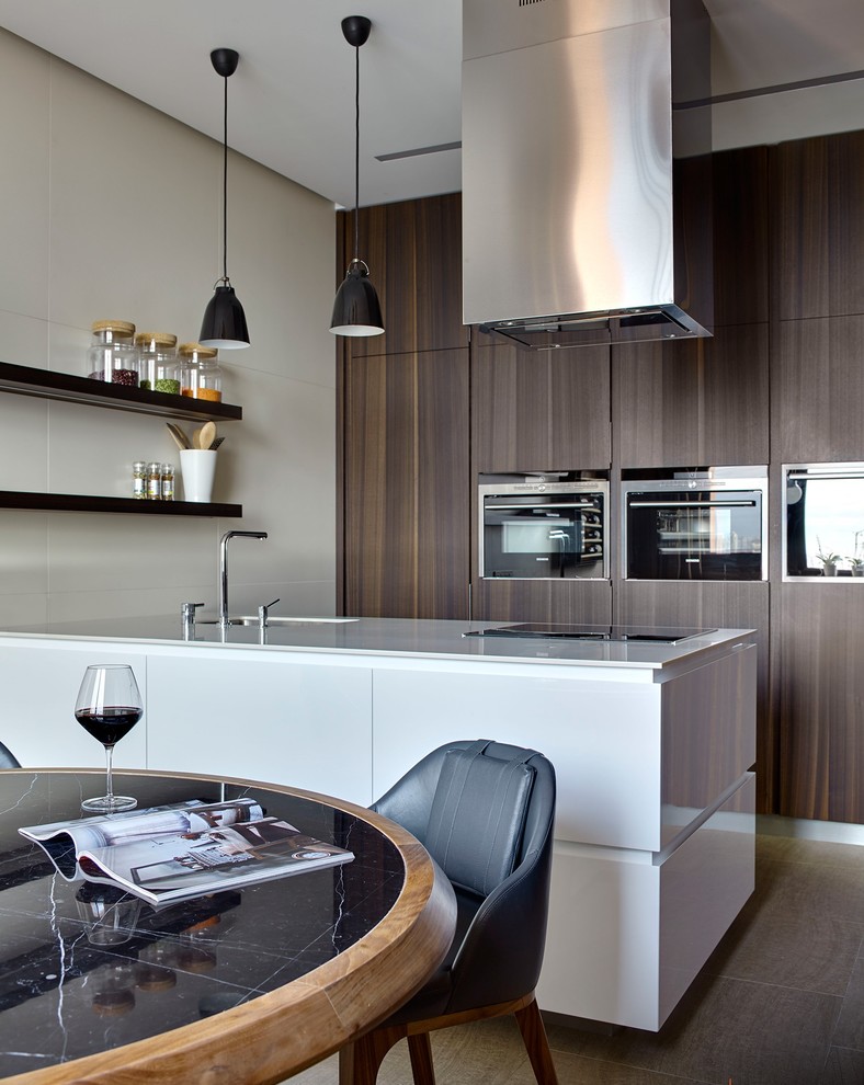 Example of a trendy galley eat-in kitchen design in Moscow with flat-panel cabinets, black appliances and an island