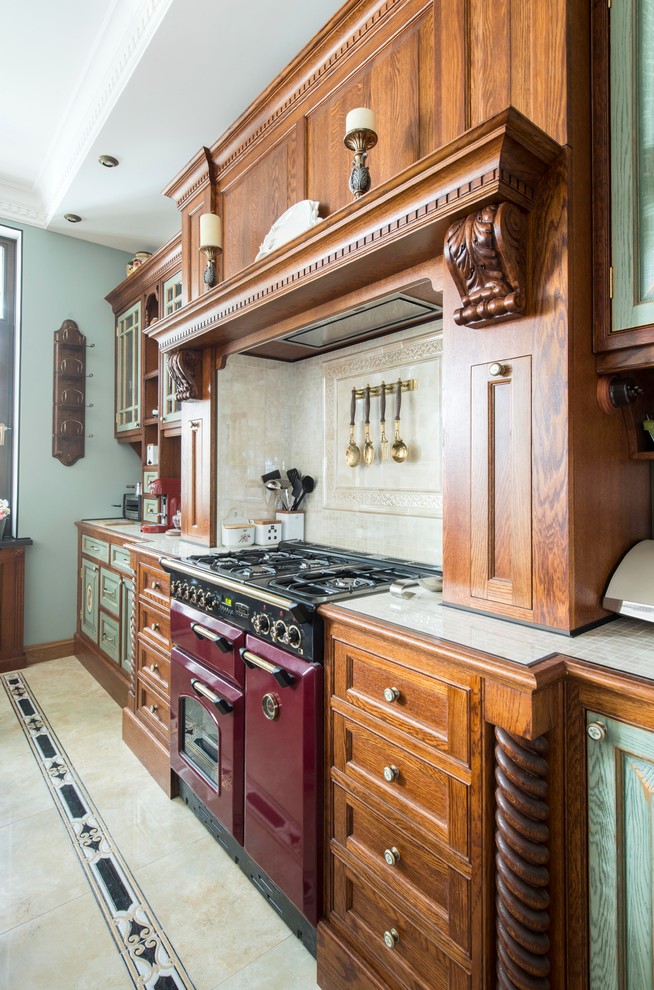 Design ideas for a medium sized victorian u-shaped open plan kitchen in Moscow with raised-panel cabinets, tile countertops, beige splashback, ceramic splashback, coloured appliances, ceramic flooring, an island, beige floors and medium wood cabinets.