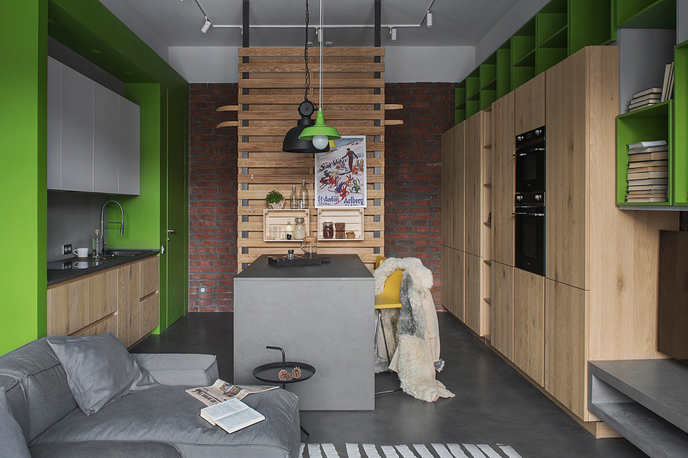 This is an example of an urban galley open plan kitchen in Moscow with a built-in sink, flat-panel cabinets, grey splashback, black appliances and an island.