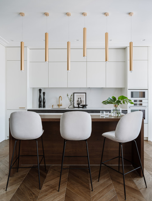 Chic and Stylish: Modern White Kitchen Cabinets with a Wooden Kitchen Island and Gold Pendants