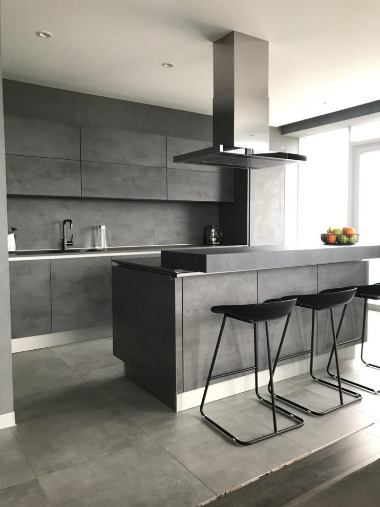 Design ideas for a large u-shaped open plan kitchen in Other with flat-panel cabinets, grey cabinets, concrete worktops, an island and grey worktops.