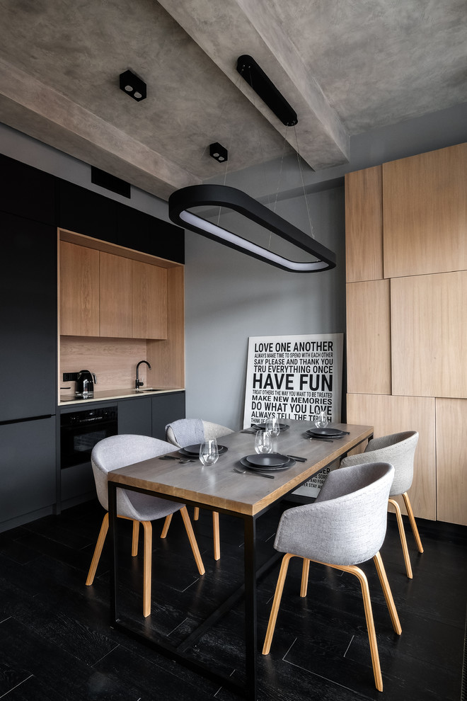 Small trendy single-wall black floor kitchen photo in Moscow with an undermount sink, flat-panel cabinets, black cabinets, beige backsplash and black appliances