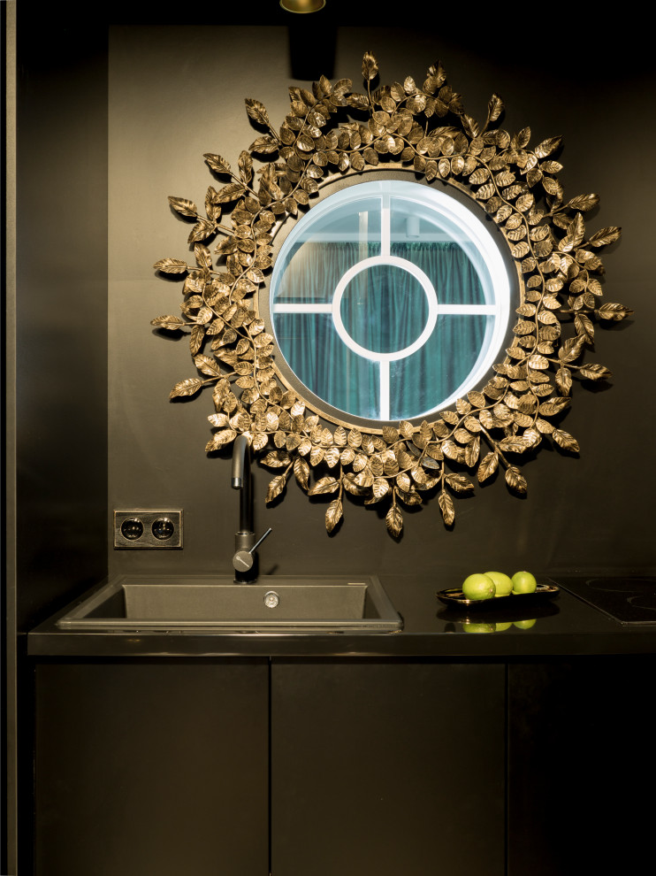 Photo of a small contemporary single-wall kitchen in Other with a submerged sink, flat-panel cabinets, black cabinets, composite countertops, black splashback, window splashback, medium hardwood flooring, no island and black worktops.