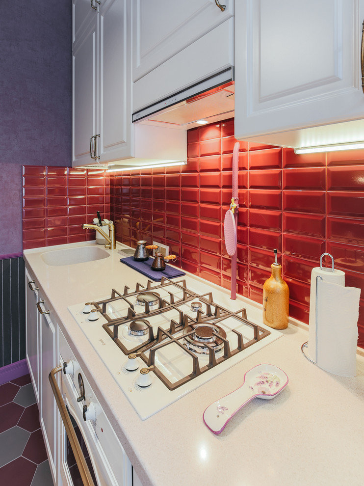 Small classic single-wall enclosed kitchen in Moscow with an integrated sink, recessed-panel cabinets, beige cabinets, composite countertops, red splashback, metro tiled splashback, white appliances, porcelain flooring, no island, red floors and beige worktops.