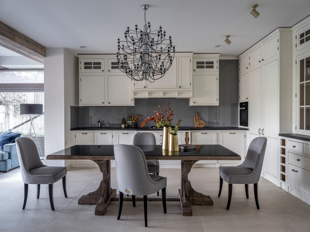 Kitchen - transitional l-shaped kitchen idea in Moscow with recessed-panel cabinets, no island, white cabinets, gray backsplash, black appliances and gray countertops