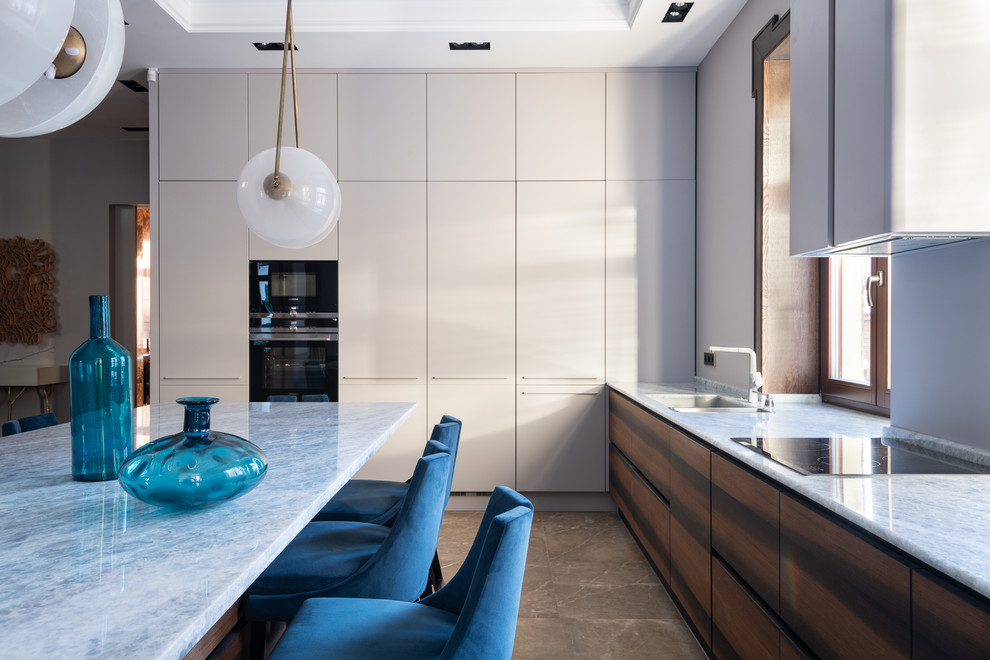 Immagine di una cucina design con lavello sottopiano e ante in legno bruno
