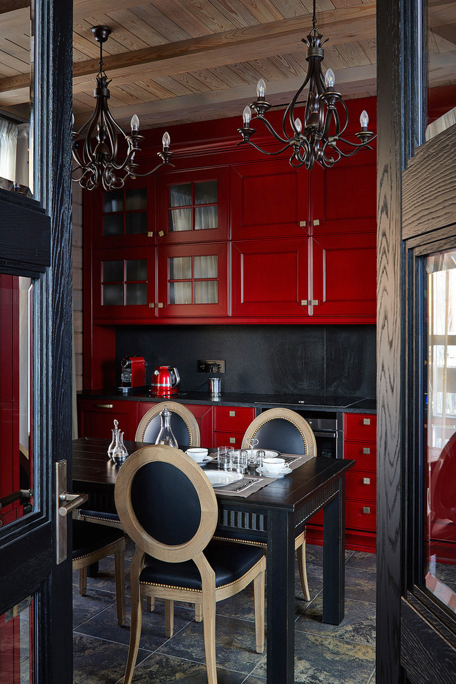 Réalisation d'une cuisine design avec un placard avec porte à panneau encastré, des portes de placard rouges, une crédence noire, un électroménager noir, un sol noir et plan de travail noir.