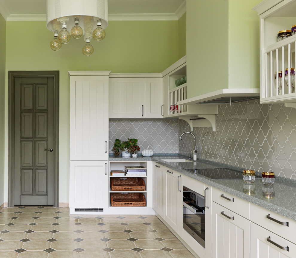 Design ideas for a traditional l-shaped kitchen in Moscow with a submerged sink, recessed-panel cabinets, white cabinets, beige floors and grey worktops.