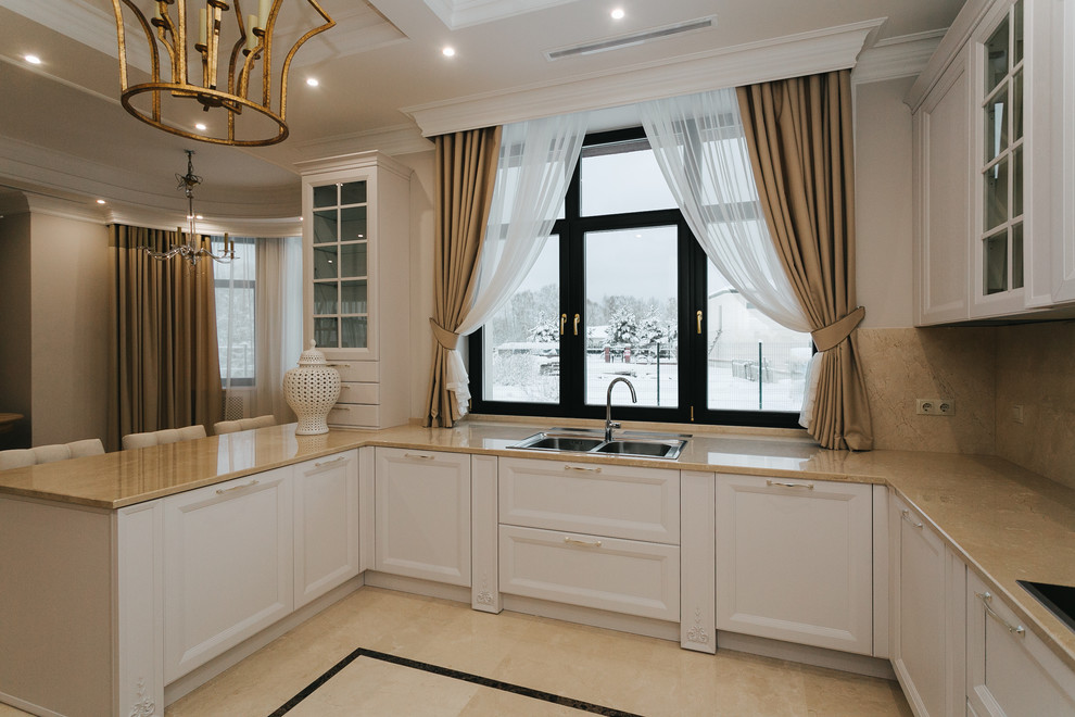 Enclosed kitchen - mid-sized transitional u-shaped enclosed kitchen idea in Moscow with beige backsplash, porcelain backsplash, an island, a drop-in sink, recessed-panel cabinets, white cabinets and beige countertops