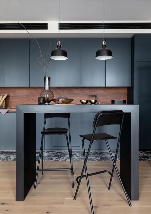 Achieve Modern Elegance with Minimalist Kitchen Designs: Wood Backsplash and Countertop, Complemented by Matte Black Cabinets