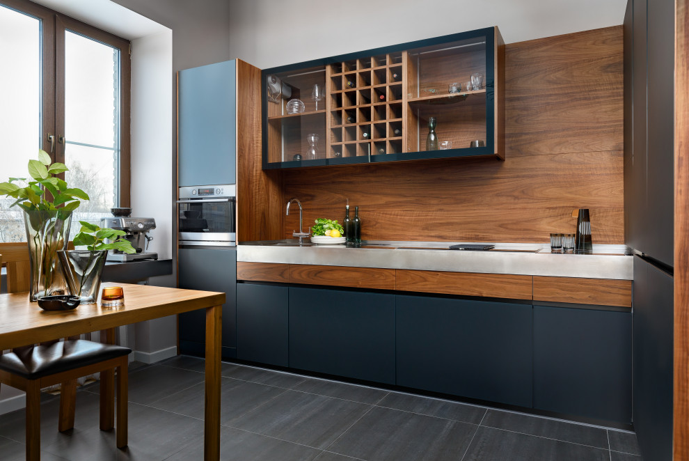 Design ideas for a medium sized contemporary l-shaped kitchen/diner in Moscow with a single-bowl sink, black cabinets, stainless steel worktops, brown splashback, wood splashback, integrated appliances, no island and grey worktops.