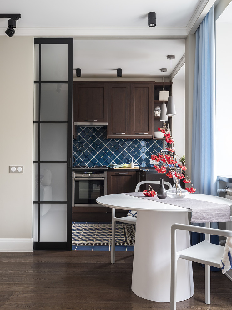 Photo of a small contemporary open plan kitchen in Moscow with dark wood cabinets, composite countertops, ceramic splashback, stainless steel appliances, ceramic flooring, blue floors, blue worktops, recessed-panel cabinets and blue splashback.