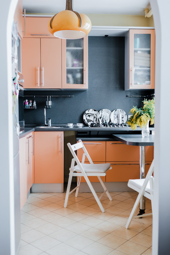 Kleine Moderne Wohnküche ohne Insel in L-Form mit flächenbündigen Schrankfronten, orangefarbenen Schränken, Mineralwerkstoff-Arbeitsplatte, Küchenrückwand in Grau, Keramikboden, beigem Boden und Tapete in Moskau