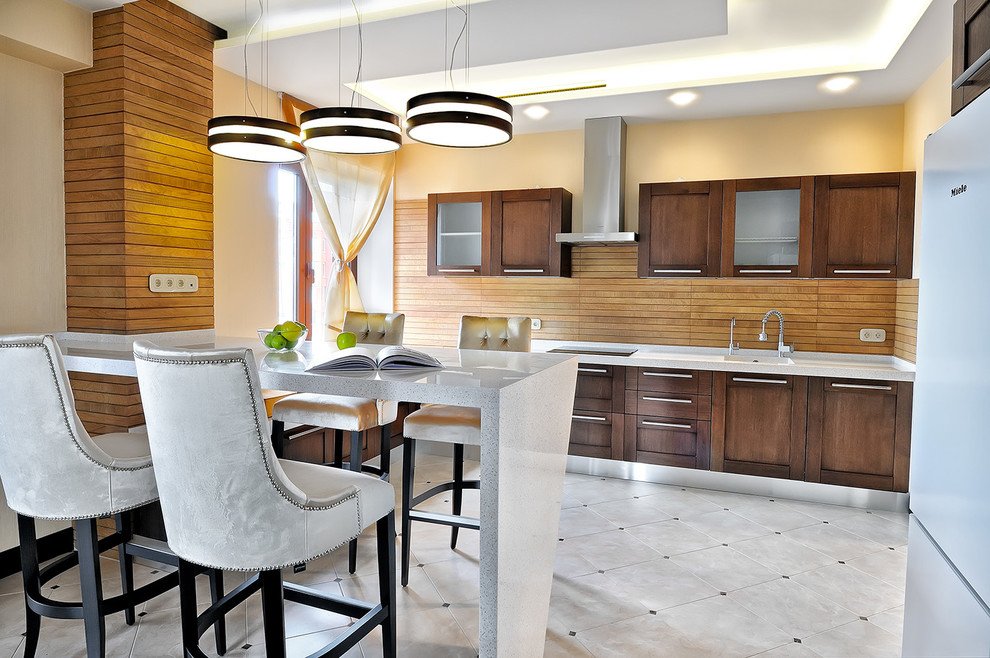 Imagen de cocina lineal actual con fregadero integrado, armarios estilo shaker, puertas de armario de madera en tonos medios, salpicadero marrón y suelo gris