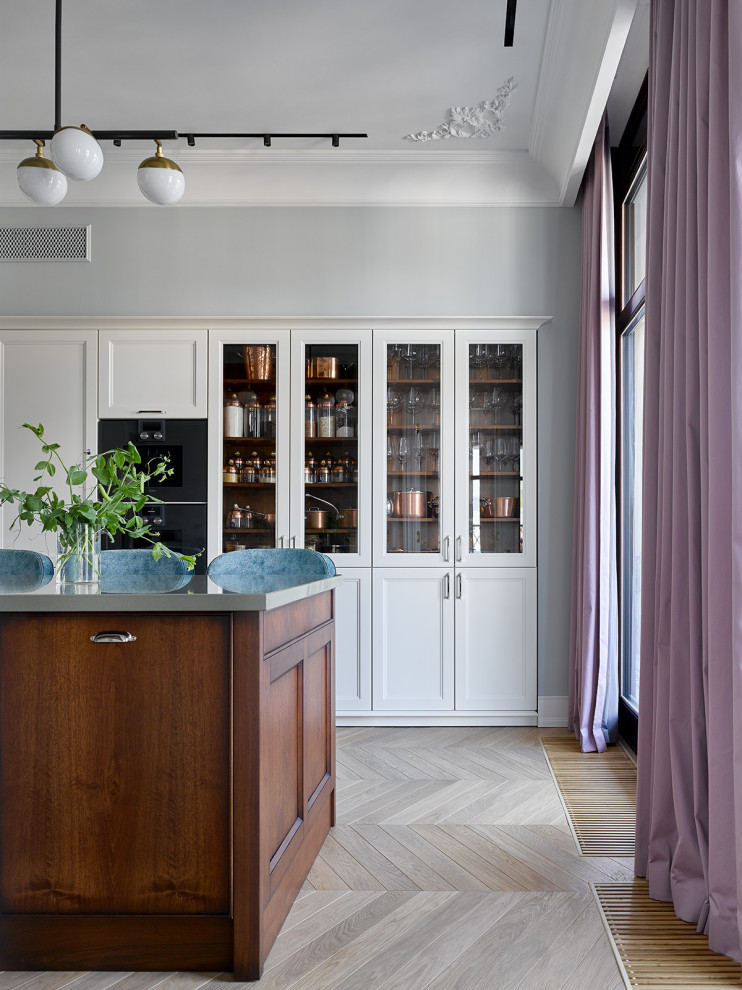 Enclosed kitchen - large contemporary l-shaped light wood floor and yellow floor enclosed kitchen idea in Moscow with an integrated sink, raised-panel cabinets, white cabinets, quartz countertops, white backsplash, ceramic backsplash, black appliances, an island and green countertops