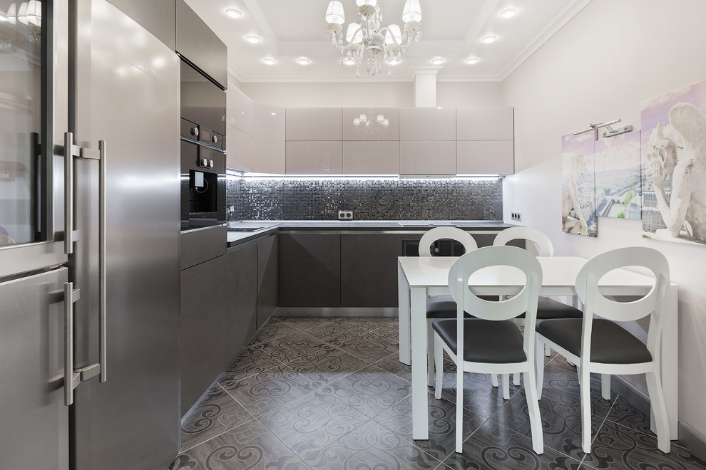 Contemporary l-shaped kitchen in Moscow with flat-panel cabinets, grey cabinets, black splashback, mosaic tiled splashback, black appliances and no island.