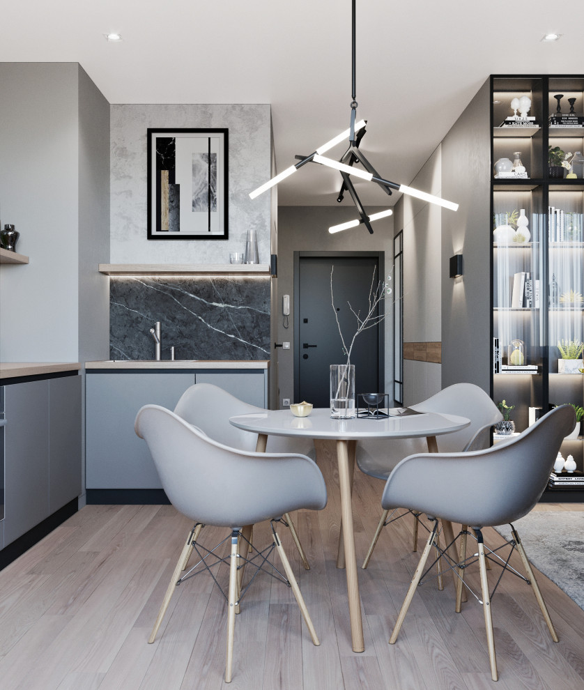 Immagine di una sala da pranzo aperta verso il soggiorno minimal di medie dimensioni con pavimento in laminato e pavimento beige