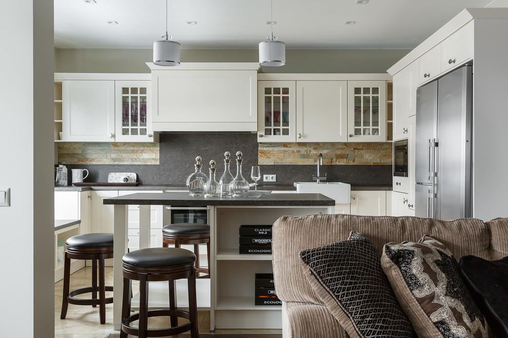 Example of a transitional u-shaped beige floor open concept kitchen design in Saint Petersburg with a farmhouse sink, white cabinets, multicolored backsplash, stainless steel appliances, an island, gray countertops and shaker cabinets