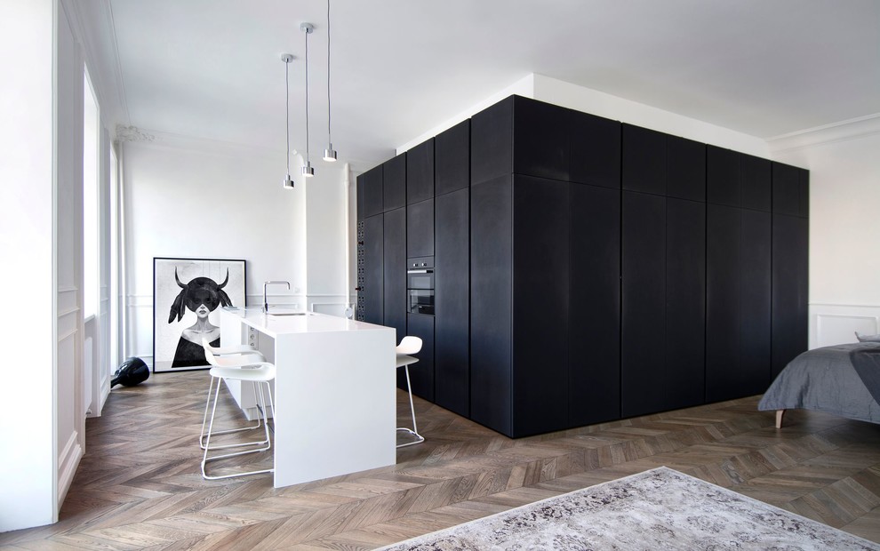 Photo of a small scandinavian kitchen in Moscow with dark hardwood flooring and brown floors.