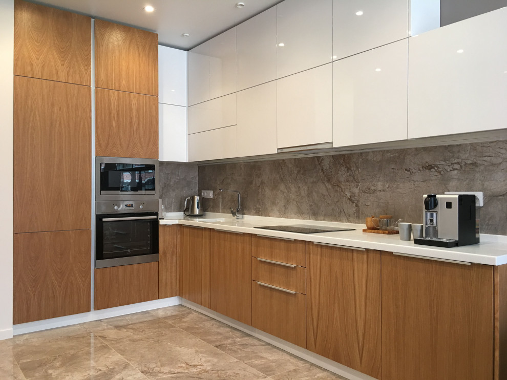 Inspiration for a medium sized contemporary l-shaped open plan kitchen in Moscow with an integrated sink, flat-panel cabinets, medium wood cabinets, composite countertops, grey splashback, porcelain splashback, black appliances, porcelain flooring, no island, grey floors and white worktops.