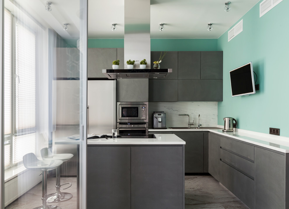 Photo of a contemporary l-shaped kitchen in Moscow with flat-panel cabinets, grey cabinets, white splashback, stone slab splashback, stainless steel appliances and an island.