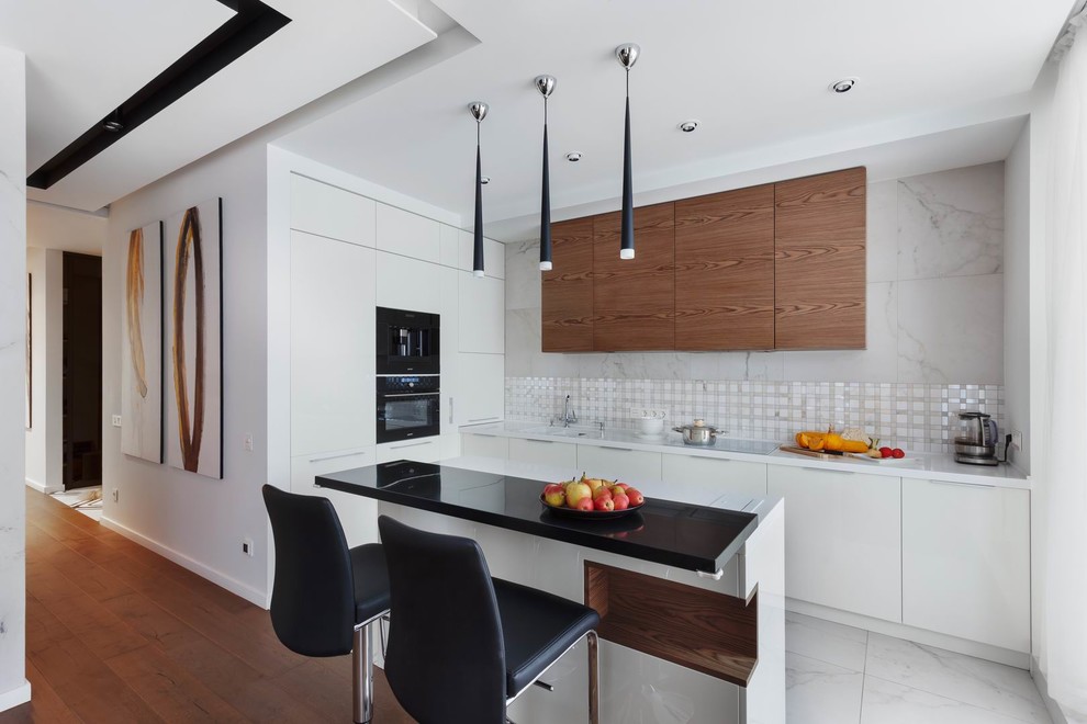 Mid-sized trendy l-shaped medium tone wood floor and brown floor open concept kitchen photo in Yekaterinburg with an undermount sink, flat-panel cabinets, white cabinets, solid surface countertops, white backsplash, porcelain backsplash, white appliances, an island and white countertops