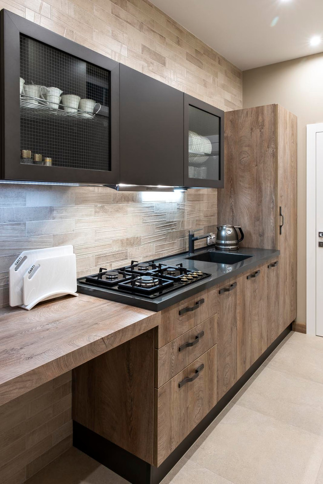 Example of a small transitional single-wall porcelain tile and beige floor enclosed kitchen design in Moscow with an integrated sink, flat-panel cabinets, medium tone wood cabinets, solid surface countertops, beige backsplash, ceramic backsplash, black appliances, no island and gray countertops
