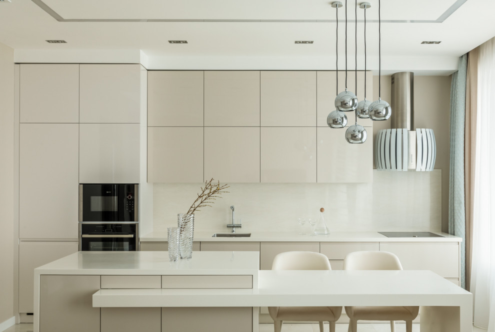 Medium sized contemporary single-wall open plan kitchen in Moscow with a submerged sink, flat-panel cabinets, beige cabinets, black appliances, an island, composite countertops, beige splashback, porcelain flooring, beige floors, beige worktops and a drop ceiling.