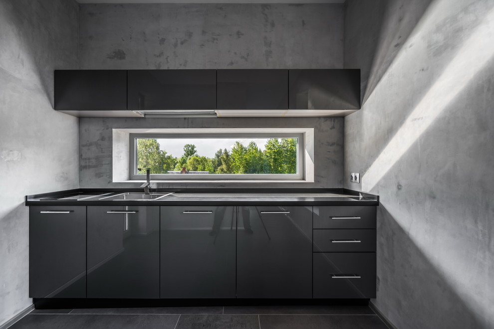 Example of a trendy single-wall gray floor kitchen design in Saint Petersburg with a drop-in sink, flat-panel cabinets, gray cabinets, gray backsplash and window backsplash