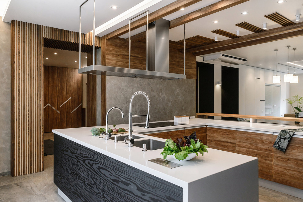Photo of a contemporary u-shaped open plan kitchen in Novosibirsk with a submerged sink, flat-panel cabinets, medium wood cabinets, an island, grey floors and white worktops.