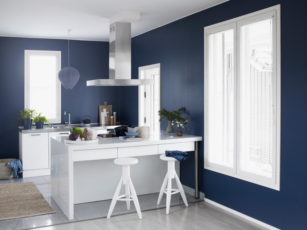 This is an example of a scandinavian galley kitchen in Saint Petersburg with flat-panel cabinets, white cabinets, an integrated sink, stainless steel worktops, a breakfast bar and grey floors.