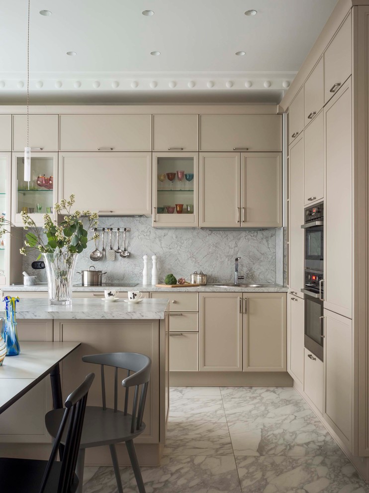 Inspiration for a contemporary l-shaped kitchen in Other with a built-in sink, recessed-panel cabinets, beige cabinets, grey splashback, stainless steel appliances, an island, grey floors and grey worktops.