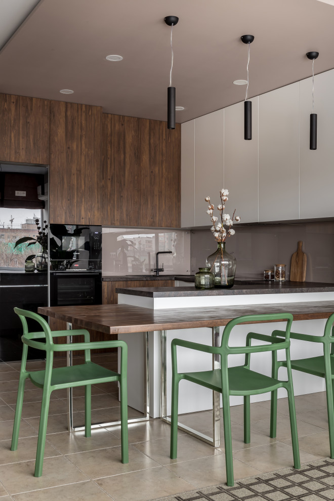 Inspiration for a small contemporary u-shaped open plan kitchen in Other with a built-in sink, flat-panel cabinets, white cabinets, laminate countertops, beige splashback, glass tiled splashback, black appliances, porcelain flooring, a breakfast bar, beige floors, black worktops and a drop ceiling.