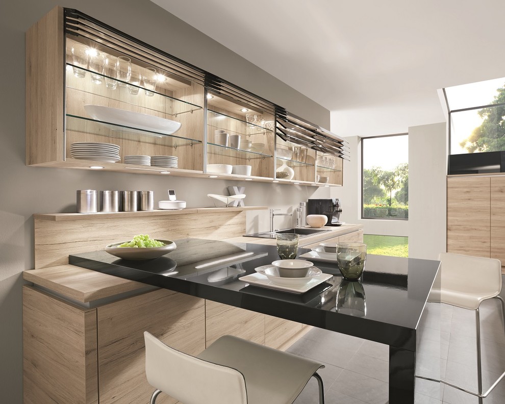 Example of a large trendy galley kitchen design in Other with flat-panel cabinets, black cabinets and an island