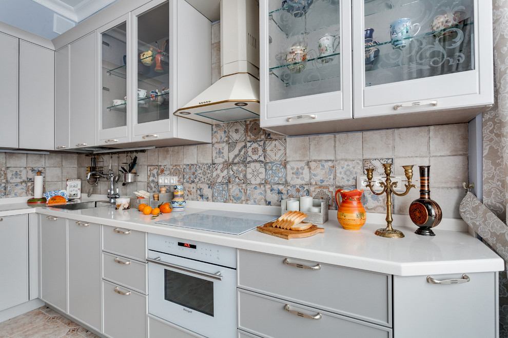 Bild på ett stort vintage vit vitt kök, med grå skåp, bänkskiva i koppar, flerfärgad stänkskydd, stänkskydd i keramik, vita vitvaror, klinkergolv i keramik, en undermonterad diskho, luckor med glaspanel och orange golv